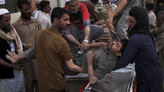 Pakistani volunteers and mine workers shift to their injured colleague on a stretcher upon arrival at a hospital in Quetta, Pakistan, Saturday, May 5, 2018.(AP)