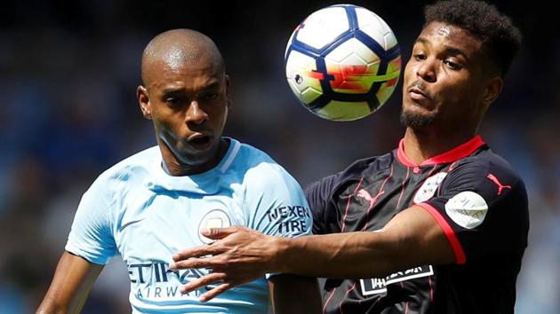 Huddersfield Town's Steve Mounie in action with Manchester City's Fernandinho during their Premier League match on Sunday.(REUTERS)