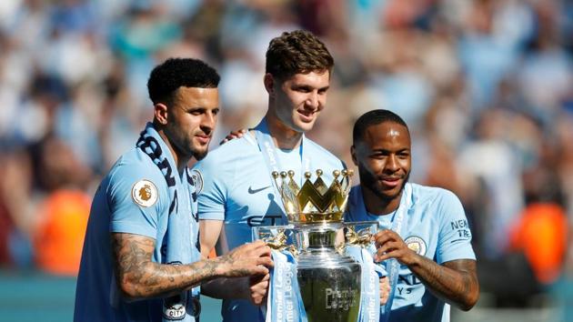 Manchester City's John Stones, Kyle Walker and Raheem Sterling pose as they celebrate with the trophy. (REUTERS) Manchester City's John Stones, Kyle Walker and Raheem Sterling pose as they celebrate with the trophy. (REUTERS)