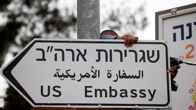 A worker hangs a road sign directing to the US embassy, in the area of the US consulate in Jerusalem, May 7, 2018.(Reuters Photo) A worker hangs a road sign directing to the US embassy, in the area of the US consulate in Jerusalem, May 7, 2018.(Reuters Photo)