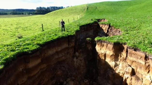 This frame grab from TVNZ video footage taken on May 2, 2018 shows a sinkhole that appeared on a dairy farm near Rotorua on New Zealand's North Island.(AFP Photo)