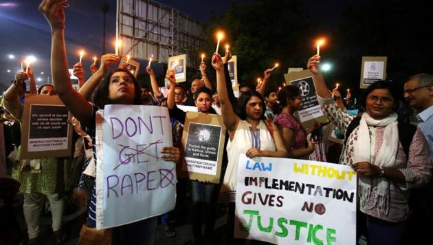 People hold candles and placards during a protest against the rape of an eight-year-old girl in Kathua.(Reuters File Photo)