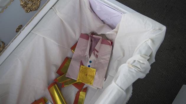 Offerings and paper shirts are placed in a coffin for a cadaver during the religious ceremony ahead of their cremation over the weekend. Uniformed students carrying flowers and burning incense paid tribute to those who have donated their bodies to medicine -- helping to train the medics of the future. (Romeo Gacad / AFP) Offerings and paper shirts are placed in a coffin for a cadaver during the religious ceremony ahead of their cremation over the weekend. Uniformed students carrying flowers and burning incense paid tribute to those who have donated their bodies to medicine -- helping to train the medics of the future. (Romeo Gacad / AFP)