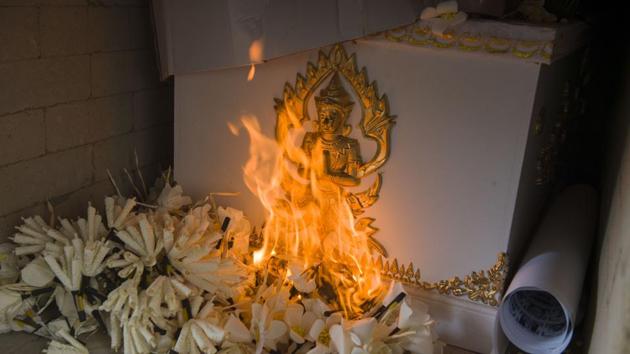 Flowers lit by a flame from the Thai Royal family burns the ceremonial bier bearing cadavers. (Romeo Gacad / AFP) Flowers lit by a flame from the Thai Royal family burns the ceremonial bier bearing cadavers. (Romeo Gacad / AFP)