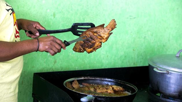 Marjorie Dorcena cooks tilapia from Taino Aqua Fish farm for a guest staying at a small hotel known in Fond Parisien, Haiti. In a country where most people live on less than $2 a day, Taino tilapia costs about $3.50 a pound, which is $2 less than the more common pink fish. (Dieu Nalio Chery / AP) Marjorie Dorcena cooks tilapia from Taino Aqua Fish farm for a guest staying at a small hotel known in Fond Parisien, Haiti. In a country where most people live on less than $2 a day, Taino tilapia costs about $3.50 a pound, which is $2 less than the more common pink fish. (Dieu Nalio Chery / AP)