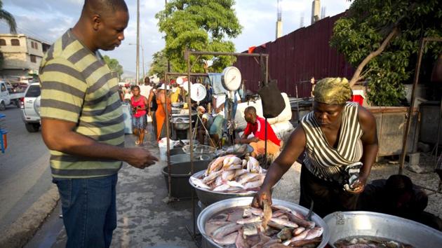 A fish vendor picks out fish for her client at the biggest fish market in Port-au-Prince, Haiti. The capital’s main fish market opens as early as 3am, selling local fish from all over the island’s coasts. “Fish is a luxury in Haiti, but we want to change that,” said Hans Wooley. (Dieu Nalio Chery /AP) A fish vendor picks out fish for her client at the biggest fish market in Port-au-Prince, Haiti. The capital’s main fish market opens as early as 3am, selling local fish from all over the island’s coasts. “Fish is a luxury in Haiti, but we want to change that,” said Hans Wooley. (Dieu Nalio Chery /AP)