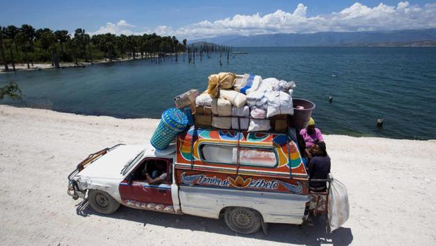 People ride in a loaded truck on the highway that leads to the Dominican Republic along Lake Azuei and is often blocked by flooding. Hans and Patrick Woolley left careers in online startups and hospital administration to invest in Haiti and try their luck at fish farming in the lake, less than an hour away from the capital of Port-au-Prince. (Dieu Nalio Chery /AP) People ride in a loaded truck on the highway that leads to the Dominican Republic along Lake Azuei and is often blocked by flooding. Hans and Patrick Woolley left careers in online startups and hospital administration to invest in Haiti and try their luck at fish farming in the lake, less than an hour away from the capital of Port-au-Prince. (Dieu Nalio Chery /AP)