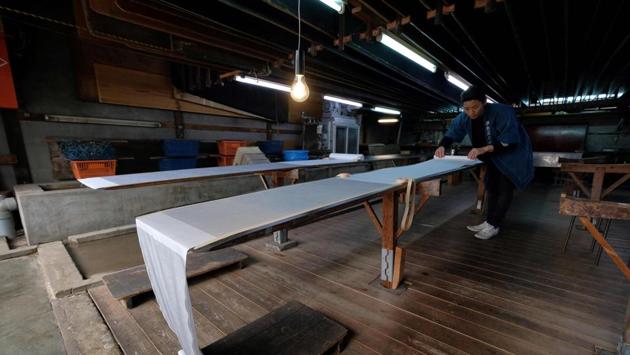 At a century-old workshop in a quiet Tokyo neighbourhood, craftsman Yuichi Hirose brushes dye across meticulously hand-cut stencils laid on fabric, using a traditional technique to produce contemporary kimono patterns. Demand for the elaborate Kimono is in decline, but a handful of artisans and entrepreneurs like Hirose, are trying to revive it. (Kazuhiro Nogi / AFP) At a century-old workshop in a quiet Tokyo neighbourhood, craftsman Yuichi Hirose brushes dye across meticulously hand-cut stencils laid on fabric, using a traditional technique to produce contemporary kimono patterns. Demand for the elaborate Kimono is in decline, but a handful of artisans and entrepreneurs like Hirose, are trying to revive it. (Kazuhiro Nogi / AFP)