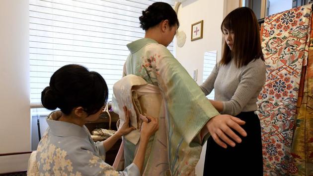 And while demand is falling among the Japanese, services renting kimonos to foreign visitors are booming. “Kimono is a piece of Japanese culture. I really wanted to experience that,” said Ruby Francisco (C), a Dutch tourist who rented a pale green kimono at Kahori Ochi’s (L) shop. A kimono outfit starts with an undergarment known as a nagajuban, over which the kimono is layered, held in place with a thick obi belt and string. (Kazuhiro Nogi / AFP) And while demand is falling among the Japanese, services renting kimonos to foreign visitors are booming. “Kimono is a piece of Japanese culture. I really wanted to experience that,” said Ruby Francisco (C), a Dutch tourist who rented a pale green kimono at Kahori Ochi’s (L) shop. A kimono outfit starts with an undergarment known as a nagajuban, over which the kimono is layered, held in place with a thick obi belt and string. (Kazuhiro Nogi / AFP)