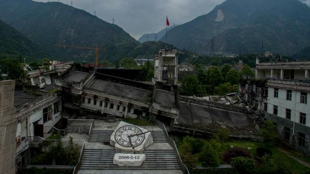 In the nearby town of Yingxiu is a giant clock stuck at the quake’s time and date. Twenty guides relive their trauma for over 2.2 million tourists a year, shepherding them down the eerily quiet streets and through the rubble of their lives. Many more work to protect remaining structures and piles of debris from the elements, as a reminder of life’s fleeting nature. (Johannes Eisele / AFP) In the nearby town of Yingxiu is a giant clock stuck at the quake’s time and date. Twenty guides relive their trauma for over 2.2 million tourists a year, shepherding them down the eerily quiet streets and through the rubble of their lives. Many more work to protect remaining structures and piles of debris from the elements, as a reminder of life’s fleeting nature. (Johannes Eisele / AFP)