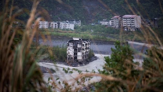 10 years on since the quake, the dilapidated buildings and the people that remain entombed in the ruins including Chen’s son who died when his middle school collapsed, stand in testimony to the calamity in Beichuan, the quake’s epicentre. On the eastern side of this city, a mass grave is home to some 3000 dead. (Johannes Eisele / AFP) 10 years on since the quake, the dilapidated buildings and the people that remain entombed in the ruins including Chen’s son who died when his middle school collapsed, stand in testimony to the calamity in Beichuan, the quake’s epicentre. On the eastern side of this city, a mass grave is home to some 3000 dead. (Johannes Eisele / AFP)