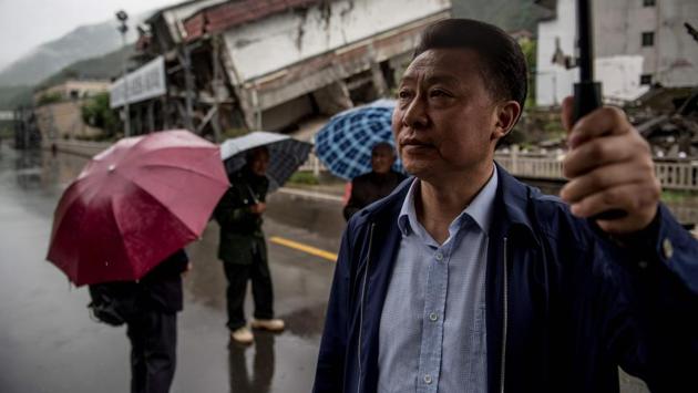 Chen (R) was working in a nearby village when the quake struck. More than 10 days later, he heard on the radio that his son had died. “It was like the sky had fallen,” he said. One hundred days after the quake, he caught a ride back to Beichuan on a military helicopter. He had lost eight relatives. Chen said he never saw his son’s body. “There was no time... our main responsibility was the rescue work.” (Johannes Eisele / AFP) Chen (R) was working in a nearby village when the quake struck. More than 10 days later, he heard on the radio that his son had died. “It was like the sky had fallen,” he said. One hundred days after the quake, he caught a ride back to Beichuan on a military helicopter. He had lost eight relatives. Chen said he never saw his son’s body. “There was no time... our main responsibility was the rescue work.” (Johannes Eisele / AFP)