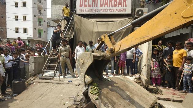 South Delhi Municipal Corporation (SDMC) officials demolish encroachments during an anti- encroachment drive at Govindpuri Kalkaji Extension in New Delhi on Wednesday. (Burhaan Kinu / HT Photo) South Delhi Municipal Corporation (SDMC) officials demolish encroachments during an anti- encroachment drive at Govindpuri Kalkaji Extension in New Delhi on Wednesday. (Burhaan Kinu / HT Photo)