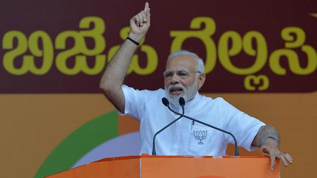 Prime Minister Narendra Modi gestures to supporters during an election rally in Bangalore, May 3(AFP)