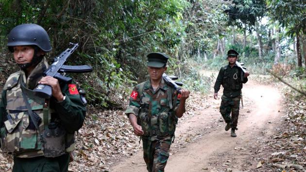 Kachin Independence Army fighters walk in a jungle path from Mu Du front line to Hpalap outpost in an area controlled by rebels. A 17-year cease-fire between the government and Kachin Independence Army was broken in 2011, when the army entered rebel territory and attacked one of their outposts. Since then, sporadic fierce combat has uprooted villagers and left hundreds of civilians dead. (Esther Htusan / AP File)