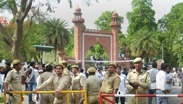 Security personnel stand guard as Aligarh Muslim University students stage a protest over Jinnah portrait issue outside the university gate in Aligarh.(PTI File Photo)