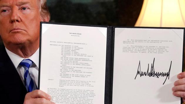 US President Donald Trump holds up a proclamation declaring his intention to withdraw from the Iran nuclear agreement after signing it in the Diplomatic Room at the White House in Washington.(REUTERS)