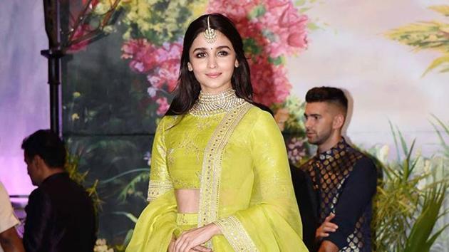Each of Alia Bhatt’s outfits is different than the one that came before. The actor wearing a neon green Sabyasachi lehenga at actor Sonam Kapoor’s wedding reception in Mumbai on Tuesday. (PTI)