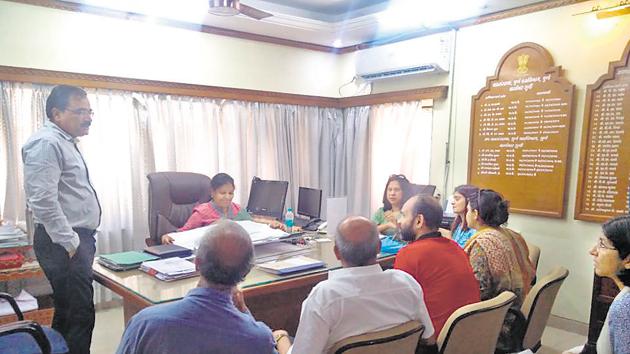 A Sreelakshmi, deputy conservator of forest(centre,seated), interacting with residents of Deccan on Wednesday.(HT PHOTO)