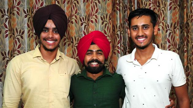 (From Left) Tenth rank holder Gurbeer Singh Sohal; Japneet Singh, 41st rank and Amandeep Kumar, 100th rank in Chandigarh on Thursday.(Ravi Kumar/HT)
