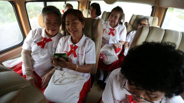 Wearing crisp red-and-white uniforms, a group of 60-year-olds pile into a bus, smiling broadly as they make their way to the School for the Elderly in Chiang Rak Noi subdistrict in Ayutthaya, a province in Thailand. (Athit Perawongmetha / REUTERS) Wearing crisp red-and-white uniforms, a group of 60-year-olds pile into a bus, smiling broadly as they make their way to the School for the Elderly in Chiang Rak Noi subdistrict in Ayutthaya, a province in Thailand. (Athit Perawongmetha / REUTERS)