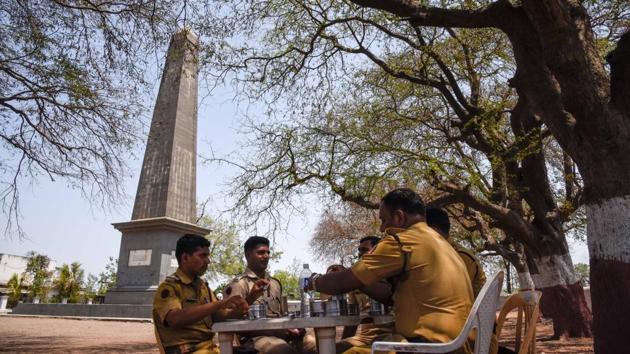 Police officials take a break from their duty at the Vijay Stambh (victory memorial) at Bhima Koregaon in Pune. (SANKET WANKHADE/HT PHOTO)