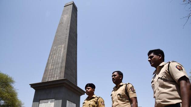 Police officials keeps a watch around the Vijay Stambh (victory memorial) in Bhima Koregaon in Pune. (SANKET WANKHADE/HT PHOTO)