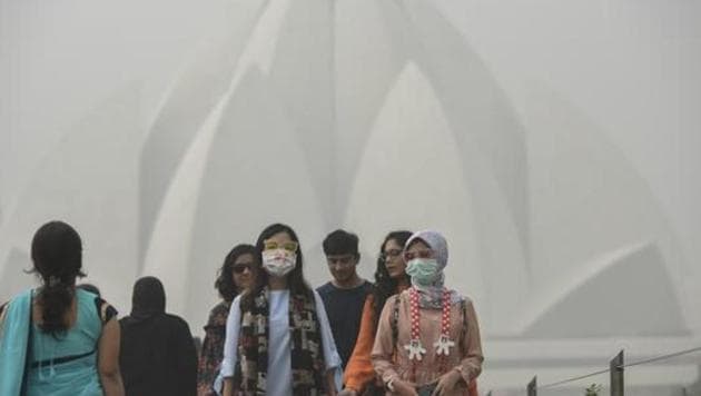Foreign tourists wearing masks as they visit Lotus Temple on a smoggy morning, in New Delhi, India, on Tuesday, November 7, 2017. (HT File Photo) Foreign tourists wearing masks as they visit Lotus Temple on a smoggy morning, in New Delhi, India, on Tuesday, November 7, 2017. (HT File Photo)