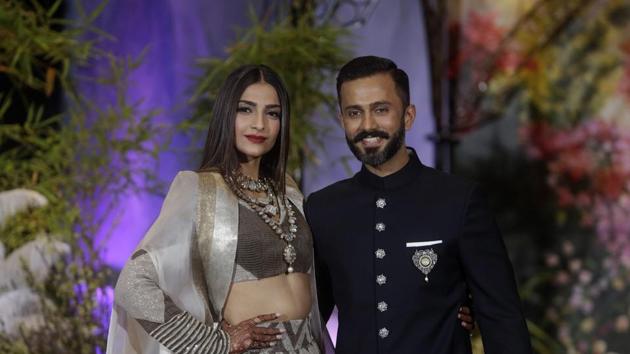 Bollywood actor Sonam Kapoor and her husband Anand Ahuja pose for photographers at their wedding reception, Mumbai, May 9(PTI)