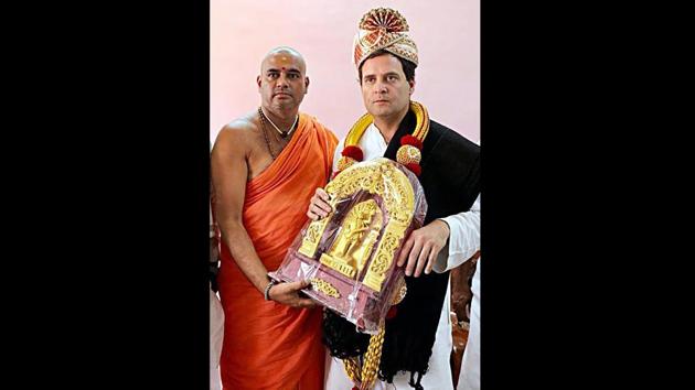 Congress President Rahul Gandhi (R) receives a souvenir from the head of Shri Kanaka Gurupeta at Kaginele Sri Niranjanananda Puri, during Janaashirvada Yatra ahead of the Karnataka assembly elections in Harihara on April 03, 2018. (PTI) Congress President Rahul Gandhi (R) receives a souvenir from the head of Shri Kanaka Gurupeta at Kaginele Sri Niranjanananda Puri, during Janaashirvada Yatra ahead of the Karnataka assembly elections in Harihara on April 03, 2018. (PTI)