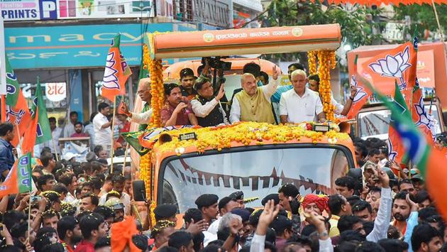 BJP President Amit Shah with Karnataka BJP chief BS Yeddyurappa and party leader Jagadish Shettar during a road show in Hubli on April 12, 2018. (PTI) BJP President Amit Shah with Karnataka BJP chief BS Yeddyurappa and party leader Jagadish Shettar during a road show in Hubli on April 12, 2018. (PTI)