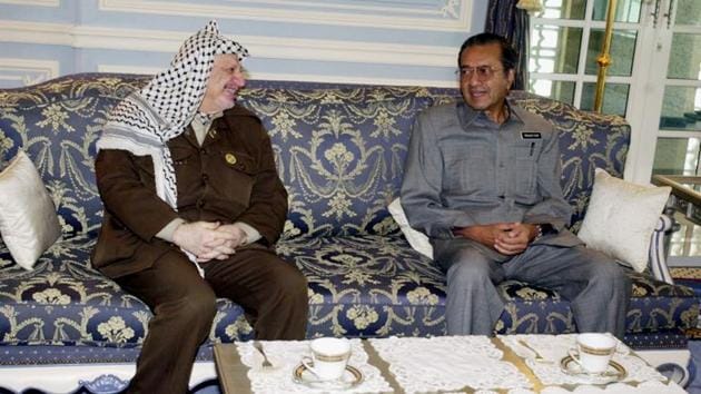 Mahathir Mohamad (R) meets with visiting Palestinian leader Yasser Arafat on August 25, 2001 in Kuala Lumpur. Not long before his retirement in 2003, Mahathir caused global outrage with an anti-Semitic speech to leaders of Islamic nations that portrayed Jews as leading a global conspiracy to oppress Muslims. (Getty Images File)