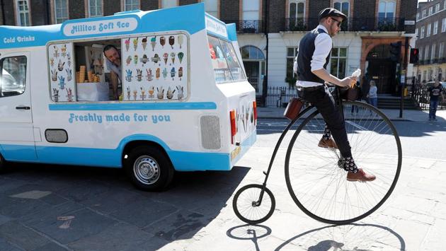 A participant in the Tweed Run cycle ride pulls away from an ice cream van in London, England. (Peter Nicholls / REUTERS) A participant in the Tweed Run cycle ride pulls away from an ice cream van in London, England. (Peter Nicholls / REUTERS)