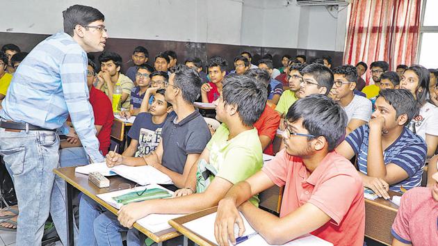 Students at IIT JEE coaching centre are all ears, listening to their professor’s lecture in order to help them get a step closer to their IIT dream.(Rahul Raut/HT Photo)