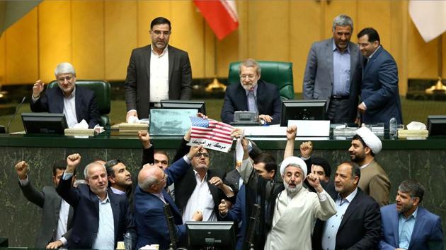 Iranian MPs prepare to burn a US flag in the parliament in Tehran after US President Donald Trump's decision to withdraw from the nuclear accord, which Iran branded “psychological warfare.” (Islamic Consultative Assembly News Agency / AFP) Iranian MPs prepare to burn a US flag in the parliament in Tehran after US President Donald Trump's decision to withdraw from the nuclear accord, which Iran branded “psychological warfare.” (Islamic Consultative Assembly News Agency / AFP)