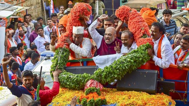 BJP National President Amit Shah campaigns in support of party candidate Katta Subramanya Naidu contesting from the Shivajinagar constituency during a road show ahead of the elections in Bengaluru on May 09, 2018. (PTI) BJP National President Amit Shah campaigns in support of party candidate Katta Subramanya Naidu contesting from the Shivajinagar constituency during a road show ahead of the elections in Bengaluru on May 09, 2018. (PTI)