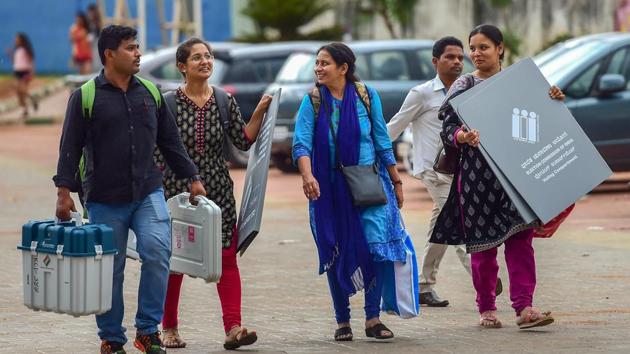 Polling officials collect EVMs and other election material on the eve of Karnataka assembly elections in Bengaluru on Friday. (PTI File Photo) Polling officials collect EVMs and other election material on the eve of Karnataka assembly elections in Bengaluru on Friday. (PTI File Photo)