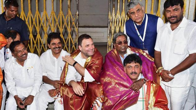 Rahul Gandhi (C), Karnataka Chief Minister Siddaramaiah and others share a light moment at the Kurudumale Ganesha temple, during an election campaign ahead of the elections in Kolar on April 07, 2018. (PTI) Rahul Gandhi (C), Karnataka Chief Minister Siddaramaiah and others share a light moment at the Kurudumale Ganesha temple, during an election campaign ahead of the elections in Kolar on April 07, 2018. (PTI)
