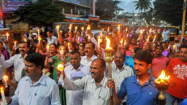 People participate in a candle march vigil organised by the Election Commission in Chikmagalur on Thursday to urge people to vote in the Karnataka assembly elections. (PTI) People participate in a candle march vigil organised by the Election Commission in Chikmagalur on Thursday to urge people to vote in the Karnataka assembly elections. (PTI)