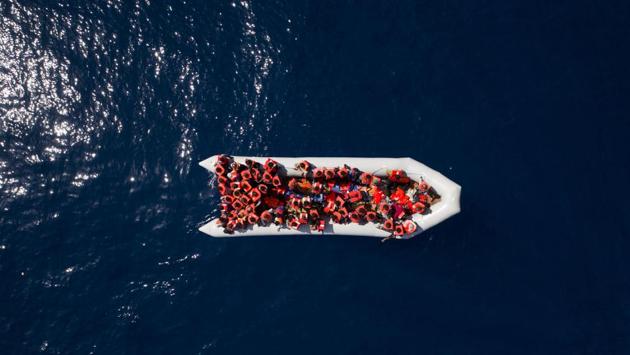 Refugees and migrants wait to be rescued by members of the Spanish NGO Proactiva Open Arms, after leaving Libya trying to reach European soil aboard an overcrowded rubber boat, north of the Libyan coast. (Felipe Dana / AP) Refugees and migrants wait to be rescued by members of the Spanish NGO Proactiva Open Arms, after leaving Libya trying to reach European soil aboard an overcrowded rubber boat, north of the Libyan coast. (Felipe Dana / AP)