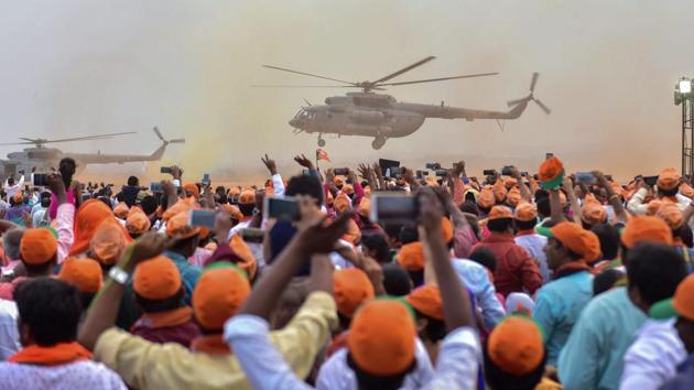 PM Narendra Modi arrives in a helicopter as BJP supporters cheer during a public rally ahead of the Karnataka assembly elections in Bengaluru on May 03, 2018. (PTI) PM Narendra Modi arrives in a helicopter as BJP supporters cheer during a public rally ahead of the Karnataka assembly elections in Bengaluru on May 03, 2018. (PTI)