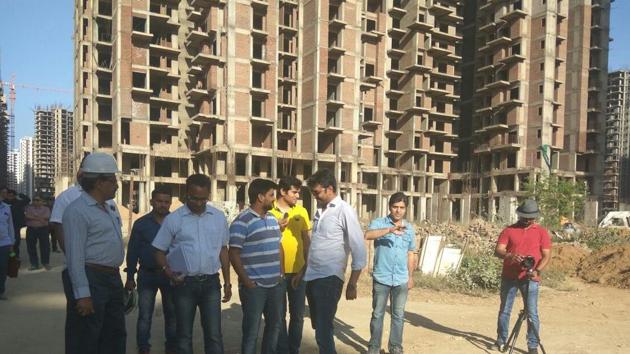 Homebuyers in Amrapali projects in Noida and company representatives inspect work at a project in March 2018. Homebuyers in Amrapali projects in Noida and company representatives inspect work at a project in March 2018.