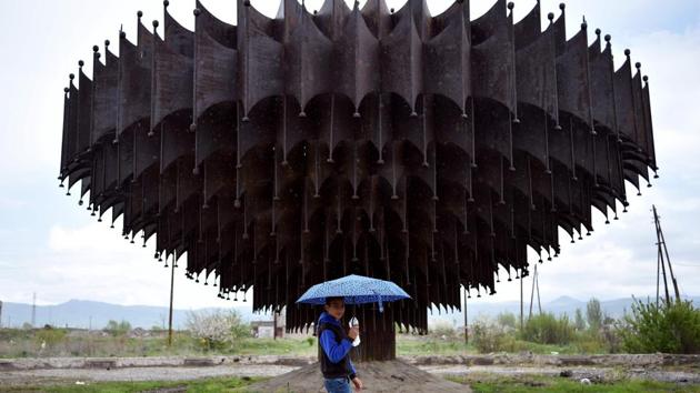 A boy holding an umbrella walks past an abandoned fountain in the town of Gyumri, northwest of Yerevan, Armenia. (Sergei Gapon / AFP) A boy holding an umbrella walks past an abandoned fountain in the town of Gyumri, northwest of Yerevan, Armenia. (Sergei Gapon / AFP)