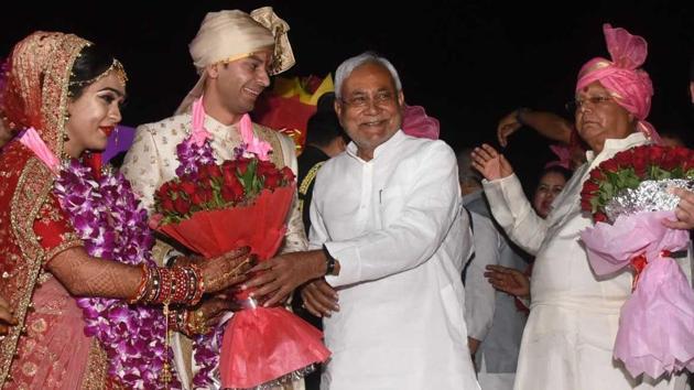 Tej Pratap and Aiswarya Rai meet Bihar chief minister Nitish Kumar as Lalu Prasad looks on ahead of the wedding ceremony in Patna.(Santosh Kumar/HT Photo)