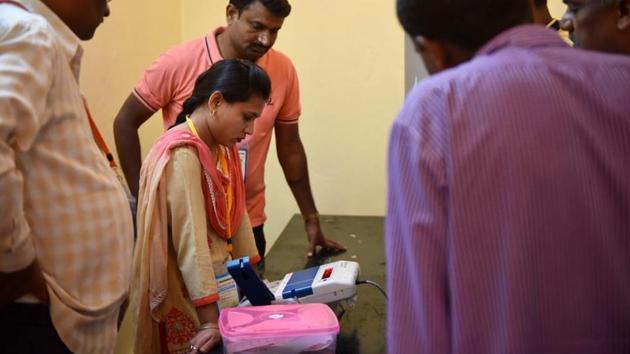 A woman waits for her turn to vote after an EVM machine at the SSB International school in Bengaluru stopped working. (Arijit Sen / HT Photo)