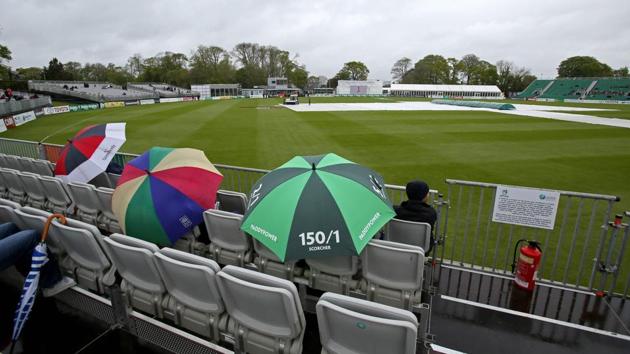 People shelter from the rain as groundsmen work on the wet pitch at Malahide cricket club, in Dublin as the start of play is delayed on the first day of the Test match between Ireland and Pakistan, on May 11, 2018. (AFP) People shelter from the rain as groundsmen work on the wet pitch at Malahide cricket club, in Dublin as the start of play is delayed on the first day of the Test match between Ireland and Pakistan, on May 11, 2018. (AFP)