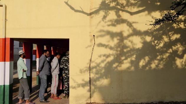 People wait outside a polling station to cast their votes in Bengaluru. (AP Photo) People wait outside a polling station to cast their votes in Bengaluru. (AP Photo)