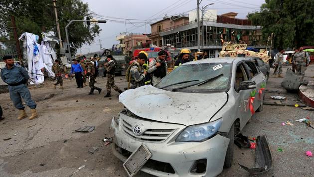 Afghan security forces inspect a damaged vehicle after blasts in Jalalabad city.(Reuters Photo)