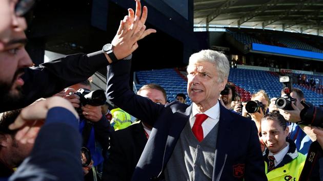 Arsenal manager Arsene Wenger waves to the fans at the end of their match against Huddersfield Town.(REUTERS)