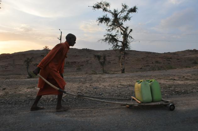 Bhopal, India - May 13, 2018: A priest carrying water for a temple in Budelkhand area near Prithvipur in Madhya Pradesh.(Mujeeb Faruqui/HT Photo)